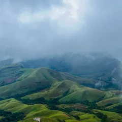 As you climb higher, the clouds often roll in, creating a magical, misty atmosphere over the Kudremukha valleys. It's a truly immersive nature experience.