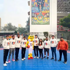 A group photo of our unified coaching team, including our mascot, Benny the Tiger. We work together to create a supportive and expert-led environment for all our athletes.
