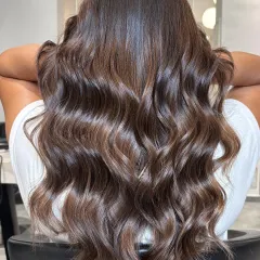 Balayage done right. Here, rich chocolate tones melt into soft, dimensional waves for a sophisticated and modern look.
