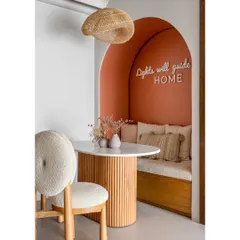 This cozy dining nook is the heart of the home. The built-in seating, custom neon sign, and warm terracotta color make it the perfect spot for family meals or a quiet morning coffee.