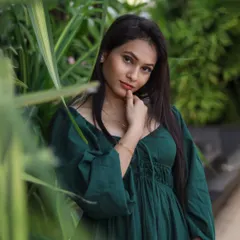 Using foliage to frame the subject's face in this outdoor portrait. This technique adds depth and a sense of being immersed in nature.
