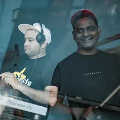 A candid shot of the Tribal Brothers in action. I'm lining up the next track while my partner, drumsticks in hand, is ready to add that live percussive punch that makes our sets so dynamic.