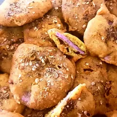 Ratalu Puri is a unique Gujarati snack made from purple yam. Slices of yam are dipped in a besan batter, sprinkled with black pepper and coriander, and fried to perfection.