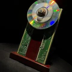A close-up of one of my custom awards, crafted from a recycled CD and a circuit board. These pieces can be customized with company branding, offering a unique way to align sustainability goals with corporate recognition.