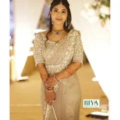 My client Greeshma looking absolutely stunning in her complete Sheer Series outfit. This full length view shows how the embellished saree, blouse, and belt come together to create a cohesive and graceful silhouette. The monotone shade allows the intricate pearl and sequin workmanship to truly shine.
