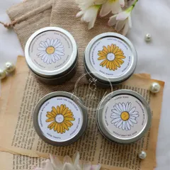 The packaging for my new Daisy Mini Candles. The simple, floral-themed label matches the cottagecore aesthetic of the candle inside.