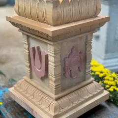 Our Shanku Chakra Nama Brindavan, or ತುಳಸಿ ಕಟ್ಟೆ (Tulasi Katte), is a sacred planter for the holy basil plant. This piece, carved from sandstone with contrasting pink stone details, represents divine harmony and is a beautiful focal point for daily prayers.