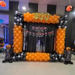 I love creating fun, themed parties, and this Halloween setup is a great example. I built a complete photo booth with a black and orange balloon frame, a shiny tinsel curtain, "BOO" foil balloons, and spooky pumpkin figures. It's perfect for office parties or home celebrations.