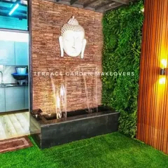 To bring a spiritual element indoors, I installed this water feature in a covered area. The design features a cascade fountain below a calming Buddha face, complemented by a vibrant green wall and artificial turf for a touch of nature.