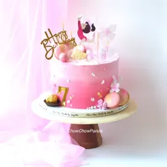 A full view of the gymnastics-themed cake, showing all the pretty pink details.