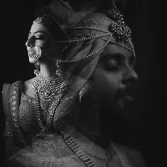 A beautiful black and white double exposure, merging the portraits of the bride and groom into a single, artistic image that symbolizes their union.
