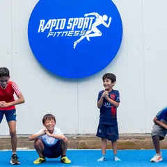 Training should be effective, but it should also be fun. Here, some of our young athletes share a lighthearted moment at our Jayamahal facility. I foster an environment where kids can build friendships and enjoy the process of getting stronger together.