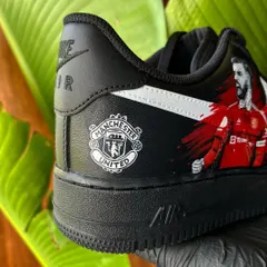 A close-up of the custom Manchester United Nike AF1s. You can see the detail on the team crest and the dynamic portrait of Bruno Fernandes. These are perfect for any football fan looking for unique fan gear.