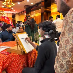 Here I am in my element, focused on sketching a guest at a lively wedding reception. My setup is professional and compact, designed to fit into any event space seamlessly.