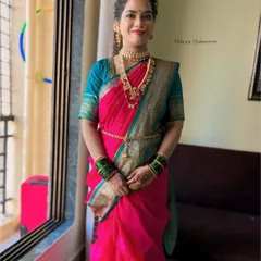 A full view of a traditional Marathi bride. I draped her Nauvari saree and created a classic makeup look with the signature half-moon bindi and gold jewelry.