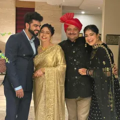 A happy family portrait is priceless. I helped style my family for our event, coordinating my dad's bandhgala, my mom's golden saree, and my brother's suit for a cohesive and elegant look.
