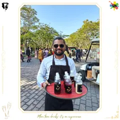 Our bartender serving pre-batched cocktails on a tray, ensuring quick and convenient service for guests on the move.