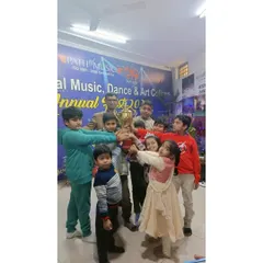 Our young champions holding the trophy at the Annual Fest. We encourage friendly competition and celebrate the achievements of all our students, building their confidence from a young age.