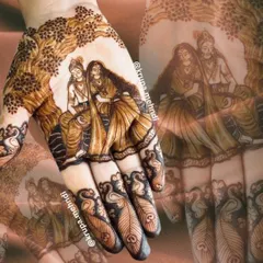An ethereal portrait of Radha and Krishna sitting together, a timeless symbol of divine love. This is a popular and meaningful choice for bridal mehndi.