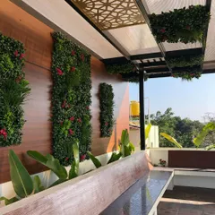 The terrace garden at the "Sanman" residence. We created a beautiful and low-maintenance green space with a vertical garden, built-in seating, and a pergola, perfect for evening relaxation.