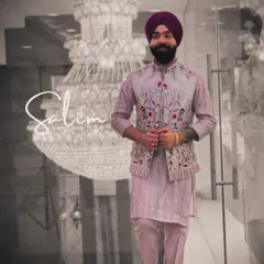A client wearing a pastel lavender kurta set with a matching floral embroidered Nehru jacket. This is a perfect look for a spring wedding or a daytime event.