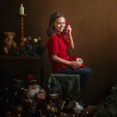 "Santa is on the line!" This portrait, with the vintage red telephone, is a perfect example of how a unique prop can spark a child's imagination and create a truly magical Christmas moment.