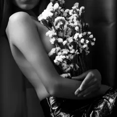 An example of my artistic boudoir work, using flowers and shadow to create an intimate, fine art portrait. This black and white shot focuses on form and emotion, telling a story without showing everything.