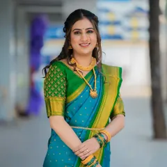 A classic engagement look for a Maharashtrian bride. The soft makeup and simple hairstyle allow the beauty of the traditional saree and gold jewelry to shine through.