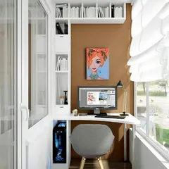 A compact and highly organized balcony workspace. This design features a custom-built unit with a desk, vertical shelving, and cabinets, making the most of a narrow space while keeping everything tidy.