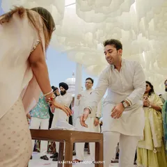 A candid moment from a wedding game, capturing the fun and laughter between guests during the celebration.