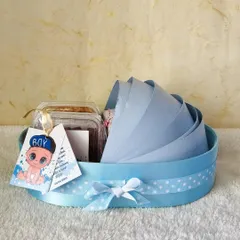 It's a boy! This cute blue bassinet hamper is the perfect way to announce the arrival of your little prince, filled with treats for everyone to enjoy.