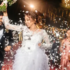 The grand reception entrance, with guests showering the happy couple in confetti. The energy and excitement of this moment is contagious.