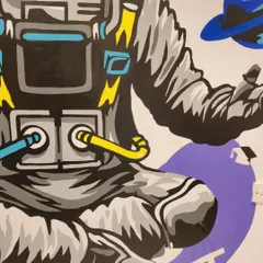 Close-up on the torso and hands of the astronaut mural. The bold lines and pops of colour against the grey suit were chosen to make the artwork stand out on the large wall.