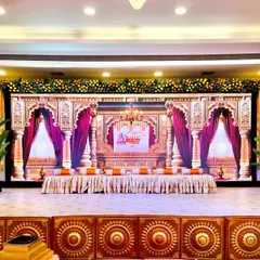 For a Ram-themed thread ceremony, we designed this grand stage setup at Siddharth Banquets. The backdrop features palatial arches and rich drapery, complemented by a stage fascia with traditional motifs and marigold floral arrangements to create a truly royal ambiance.