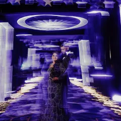 Another take on using motion blur to create a dynamic and artistic Sangeet portrait. The streaking lights give a sense of dizzying celebration, with the couple as the calm, happy center of it all.