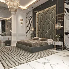 I design bedrooms that feel like a retreat from the world. This master bedroom features a floor-to-ceiling tufted headboard, marble-clad walls, and custom lighting to create an atmosphere of pure luxury.