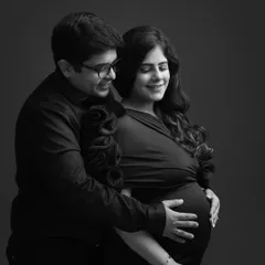 The gentle touch, the soft smiles. This black and white photo strips away everything but the pure, tender emotion between this couple as they cradle the baby bump.
