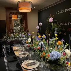 A closer look at the stunning floral centerpiece and modern place settings. Every detail is curated to create a sophisticated and cohesive dining experience.