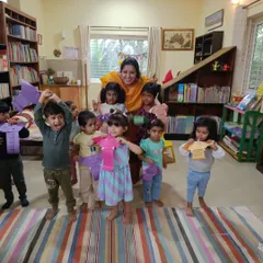 So much joy and excitement as the children display the paper elephant puppets they made. This is the wonderful result of a fun story and a creative craft session.