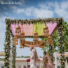 A stunning mandap setup with floral pillars and hanging kaleeras, another one of my shots featured by Incredible India.