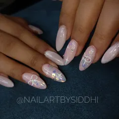 A soft and ethereal look, this set features a shimmery, light pink base with hand-painted bows, stars, and scattered rhinestones.