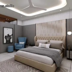 This bedroom design combines a comfortable upholstered bed with a modern accent chair, creating a cozy reading corner. The two-tone wall with paneling adds depth and character to the room.