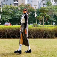 A full-length view of a favorite winter outfit. The slit in the denim skirt adds a modern touch, while the black and white layers create a classic look that’s perfect for a walk in the park on a crisp day.