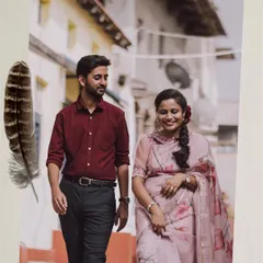 An artistic edit of a vintage-themed pre-wedding photo, with a feather and script overlay creating a poetic feel.