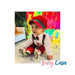 This little boy is ready for his Christmas-themed birthday party in our custom red and white outfit with suspenders and a matching cap. The details make it festive, while the design keeps it comfortable for play.