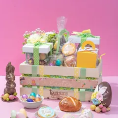 A grand Easter hamper in a wooden crate, filled with an abundance of my festive treats including a piñata egg, chocolate bunny, hot cross buns, and decorated cookies. This is the ultimate gift for a family to share.