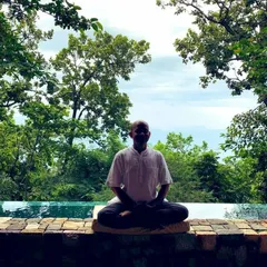Seated in a simple cross-legged position for meditation. The goal is not to force the mind silent, but to gently settle into yourself using the breath as an anchor. This is a fundamental practice for inner peace.