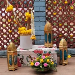This image shows the decorative elements we use to style our gift and favor stations. Moroccan-style lanterns, floral arrangements, and custom-printed boxes create an inviting and thematic corner at your event.