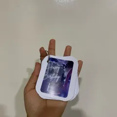 A hand holding the birthday-themed memory keychain. The compact size makes it easy to attach to keys or a bag, so your memories are always close by.