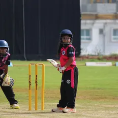 Two of our youngest players, a batter and wicket-keeper, in position during a U-10 match. It's never too early to learn the fundamentals.